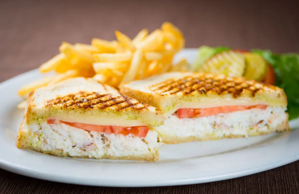 A sandwich and french fries on a plate.